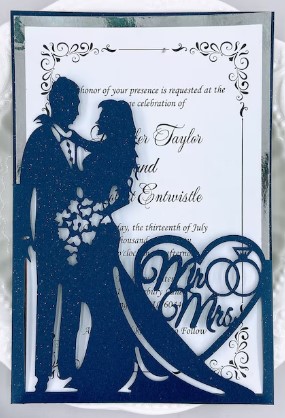 a blue wedding invitation with a couple dancing