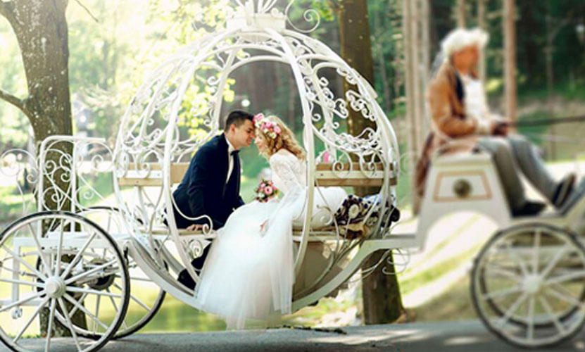 a man and woman sitting in a carriage